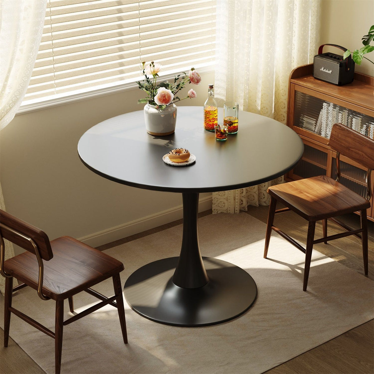 Round black table with chairs in a room with natural light