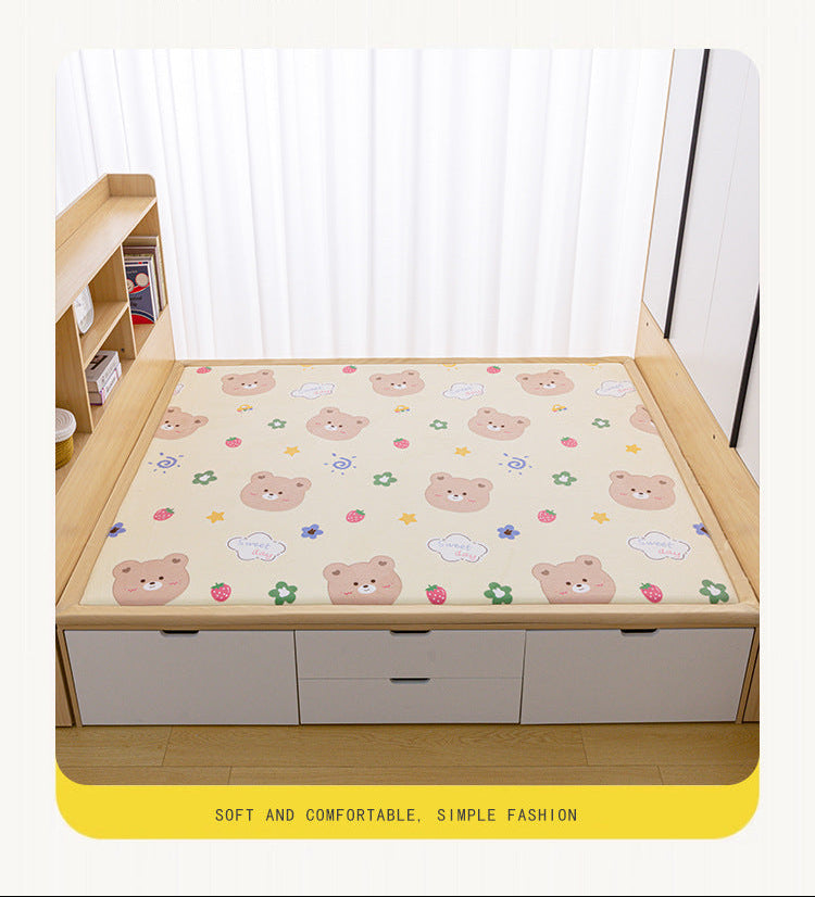 A beige foam mattress pad with a cartoon bear pattern, shown on a wooden bed frame in a bedroom setting. The image includes Chinese promotional text at the top and bottom.