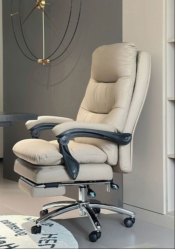 A beige faux-leather office chair with a matching footrest, shown in a modern room setting. The left side of the image features a white panel with Chinese text and graphics highlighting the product's features, including '卡其色' (khaki/beige color), '带脚踏' (with footrest), '海绵填充' (honeycomb cushion filling), and '优质PU皮' (high-quality PU leather).