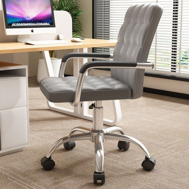 A gray tufted office chair with black armrests and a chrome five-wheel base, positioned in a modern office setting next to a desk with an iMac.