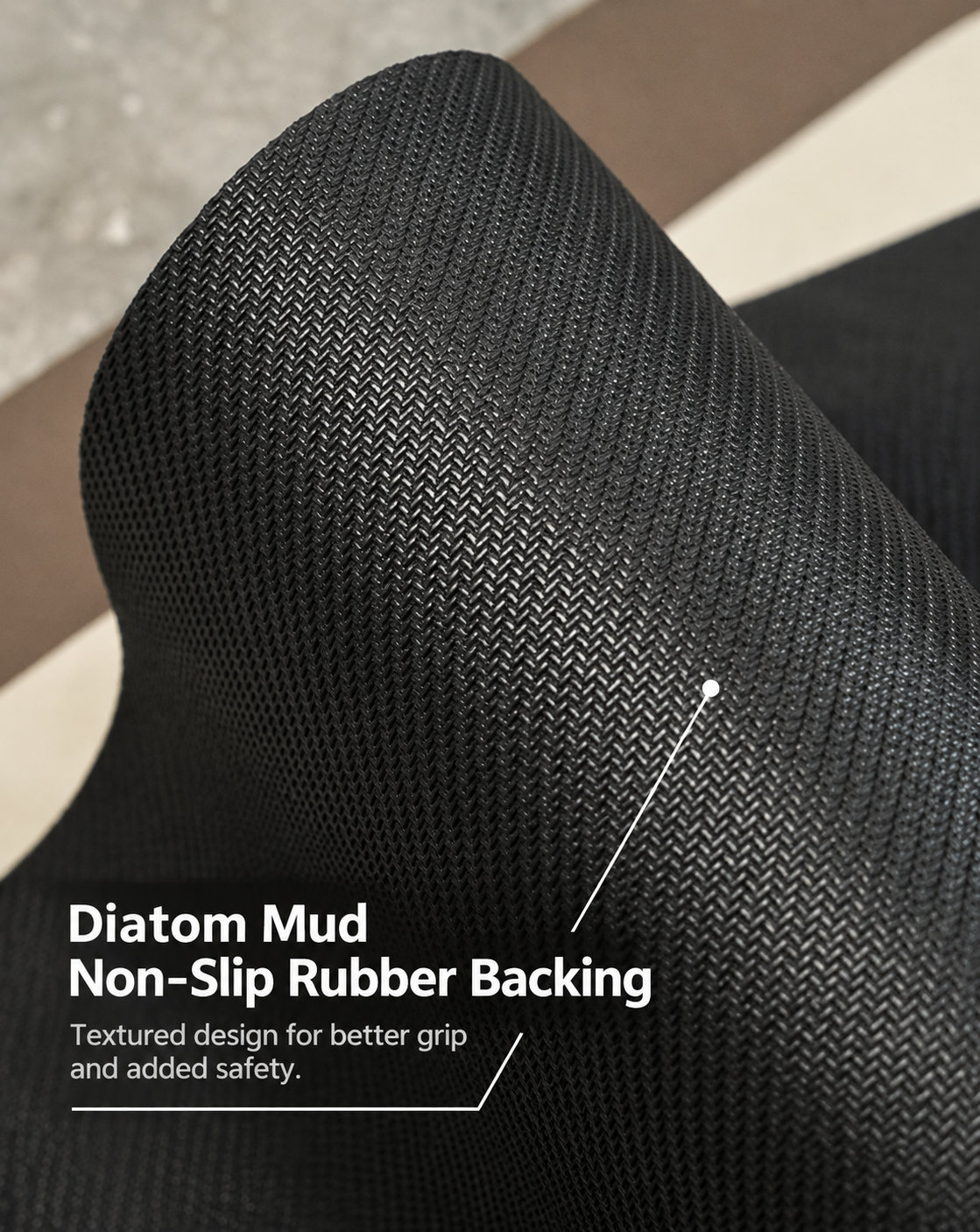 Close-up of a black textured rubber or carpet-like material roll with overlaid text reading 'Diatom Mud Non-Slip Rubber Backing' and a white pointer line highlighting the textured surface.