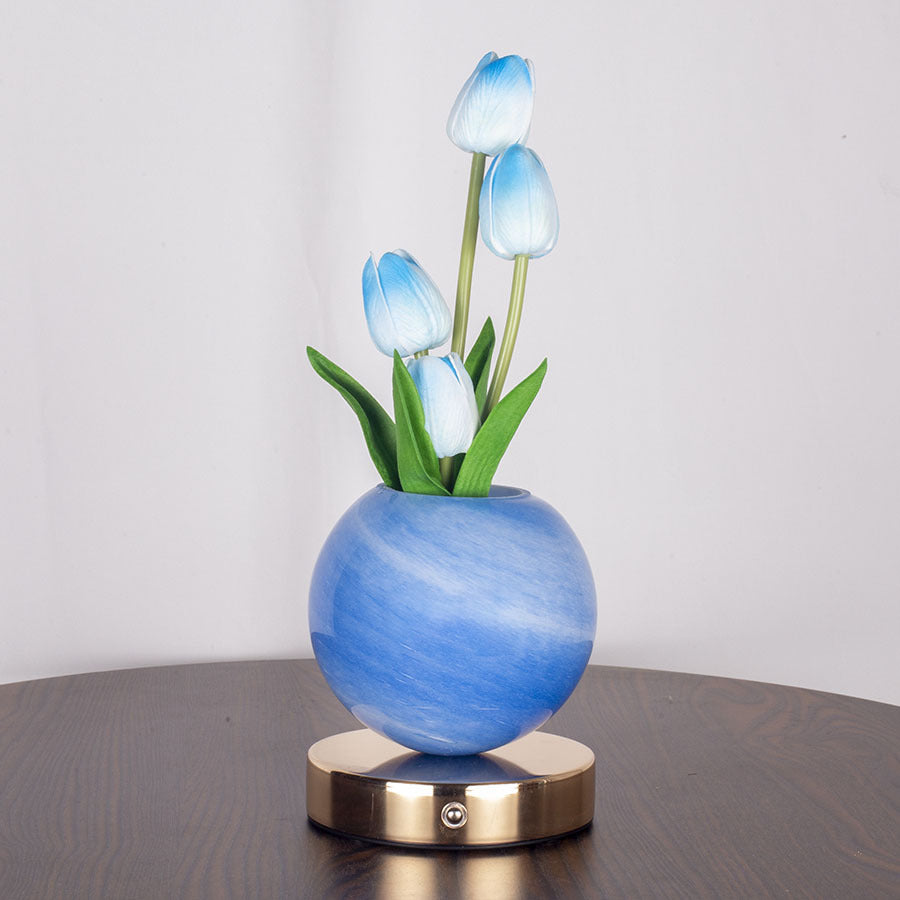 Decorative lamp with blue tulip-shaped lights on a wooden surface