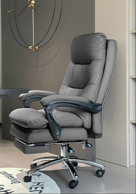 Gray upholstered office chair with a footrest, shown in a modern room setting. The left side includes a vertical informational panel with Chinese text, a hand illustration, a foam fill inset, a leather swatch, and a gray color label.