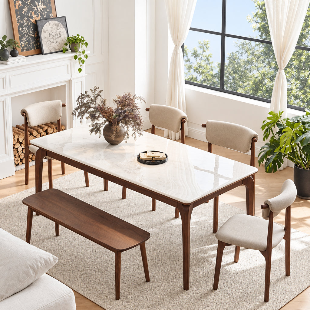 A dining table set in a bright, modern dining room with a woman standing nearby. The set includes a rectangular table with a glossy white top and dark brown wooden legs, accompanied by matching chairs and a bench.