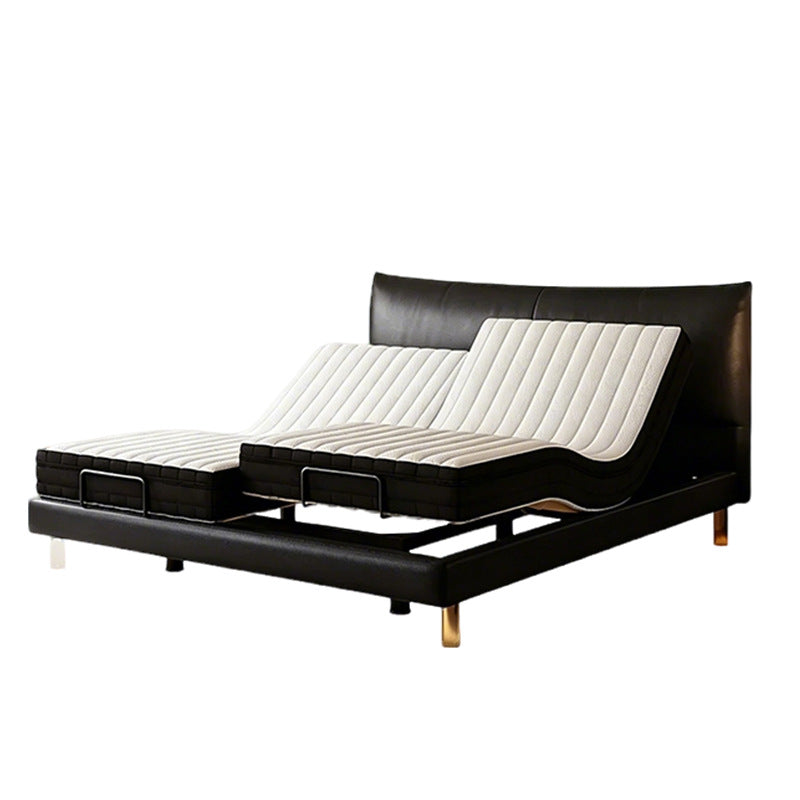 An adjustable electric bed frame with a black faux leather finish and white ribbed mattress pads, shown on a solid white background.