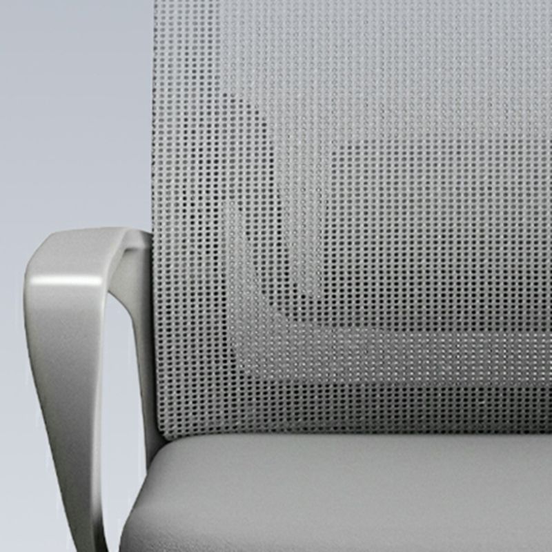 Close-up of an office chair showing a gray perforated mesh backrest and a light gray upholstered seat, with part of a curved armrest visible.